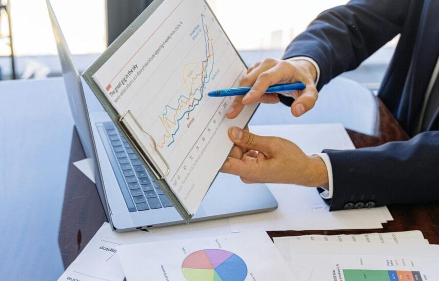 Free Business professionals discussing financial graphs and charts in an office setting. Stock Photo